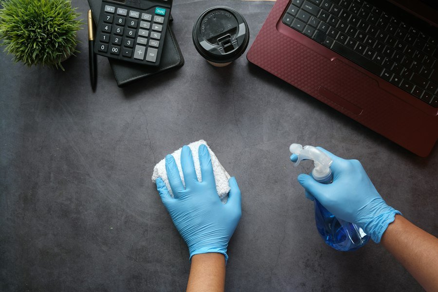 Cleaning an office desk with spray and cloth